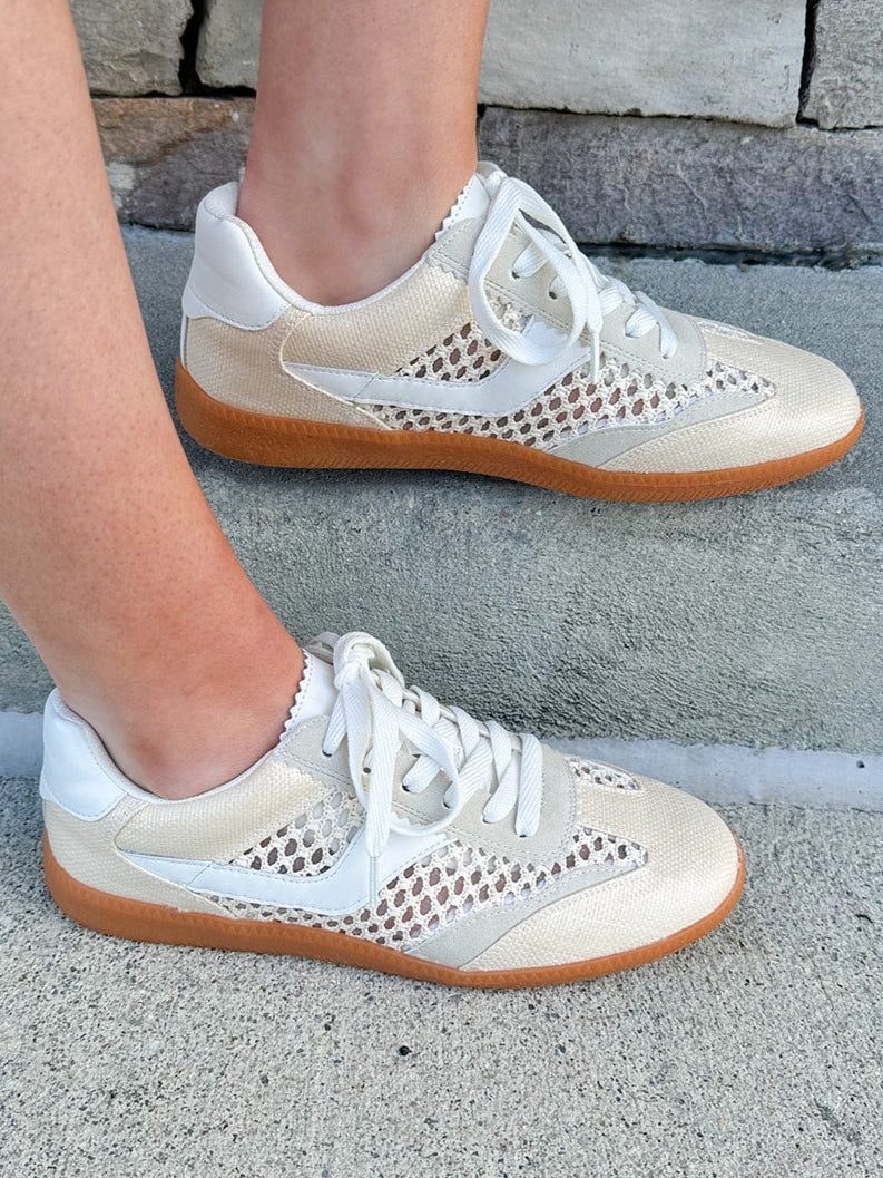 Neutral woven low-top sneakers with muted laces, round toe, and 1-inch heel, styled for casual and fashion-forward everyday looks.