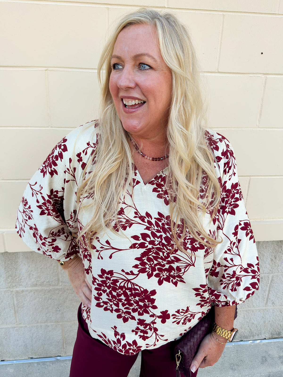 Maroon and cream cherry blossom print blouse with V-neck, 3/4 sleeves, and scalloped hem.