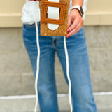 White eco-friendly cork crossbody bag with sleek design and adjustable strap, styled for casual and polished everyday looks.