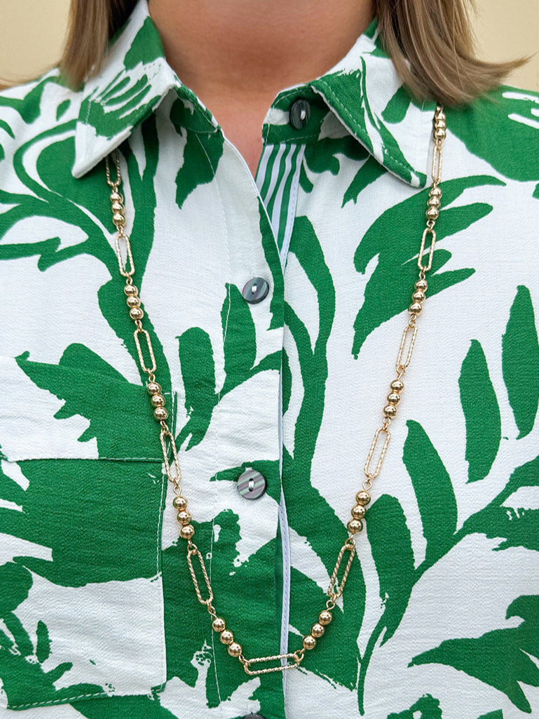 Water-resistant gold necklace with delicate beading and open oval chain, ideal for layering and everyday wear