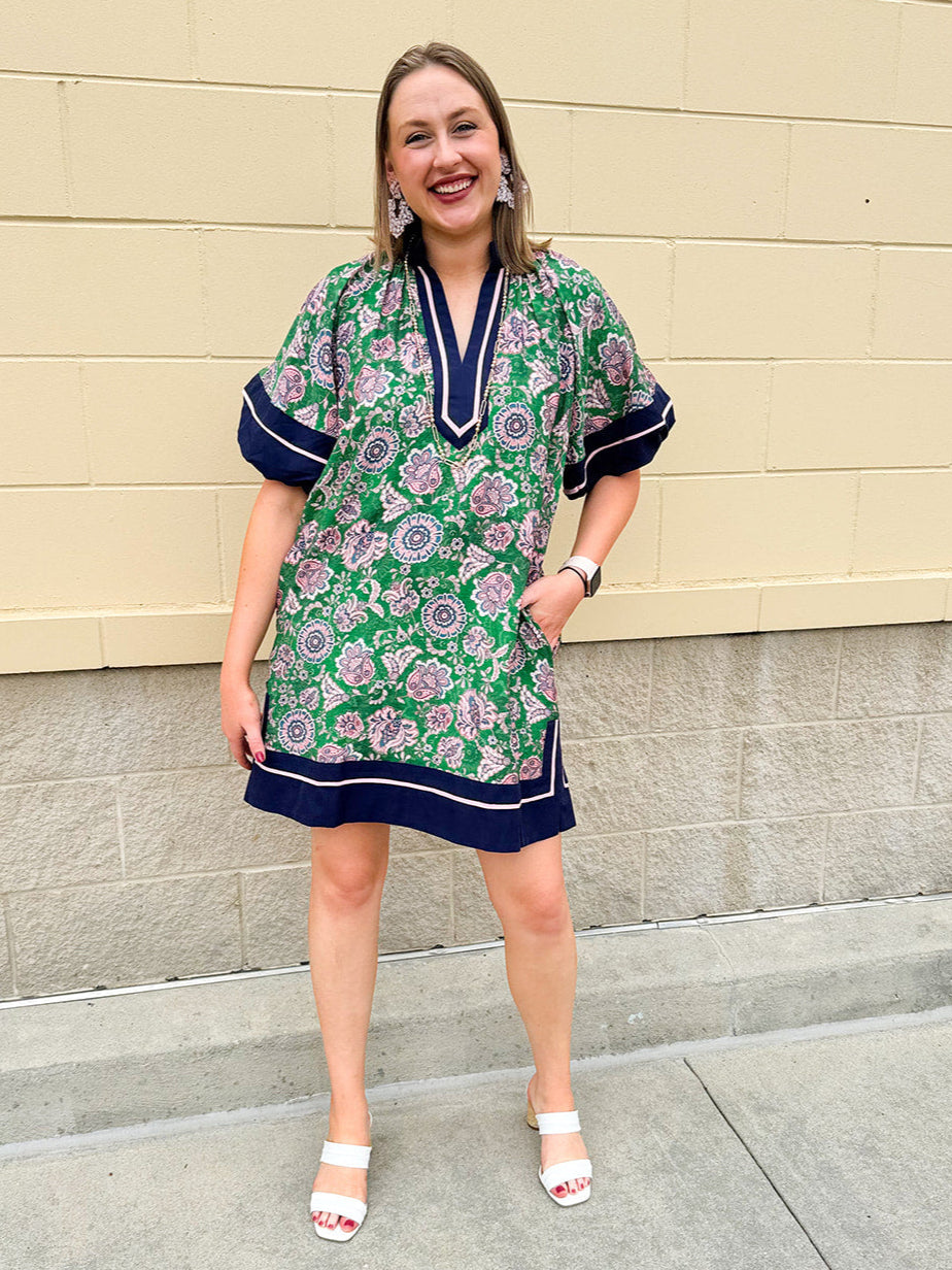 Green and pink floral paisley pullover mini dress with navy high neck, bubble sleeves, side slits, and pockets—lightweight woven fabric