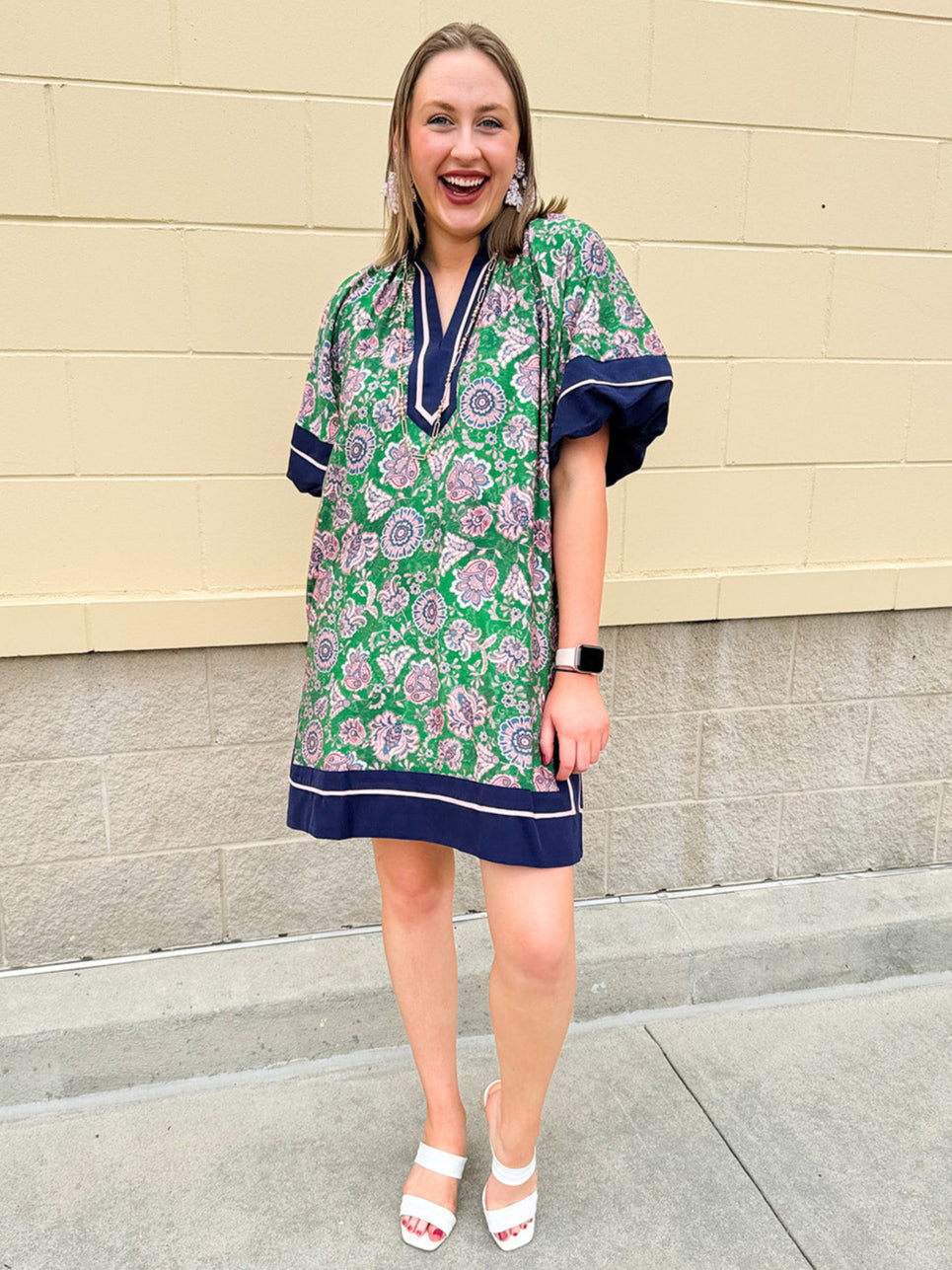 Green and pink floral paisley pullover mini dress with navy high neck, bubble sleeves, side slits, and pockets—lightweight woven fabric