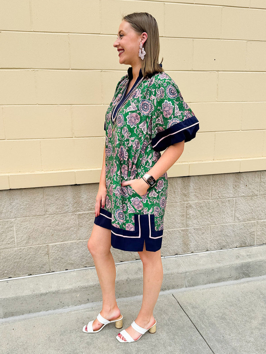 Green and pink floral paisley pullover mini dress with navy high neck, bubble sleeves, side slits, and pockets—lightweight woven fabric