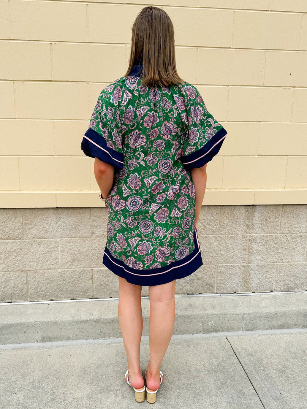 Green and pink floral paisley pullover mini dress with navy high neck, bubble sleeves, side slits, and pockets—lightweight woven fabric