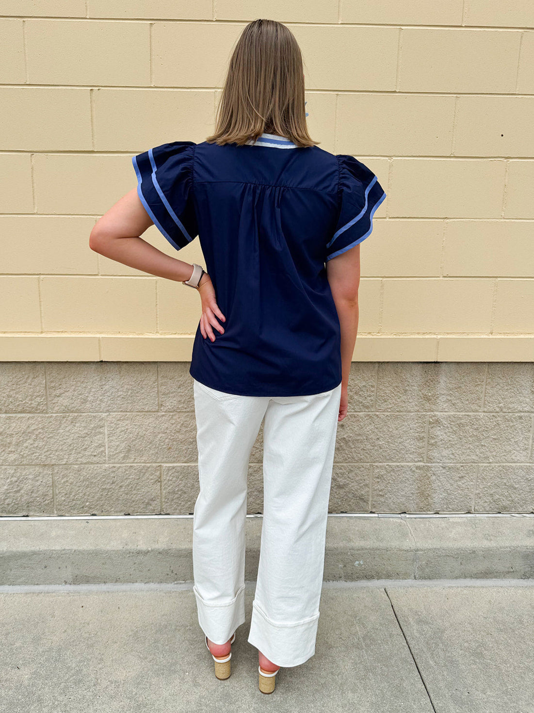 Navy embroidered flutter sleeve top with multicolor appliqué and V-neckline—lightweight and versatile for everyday wear