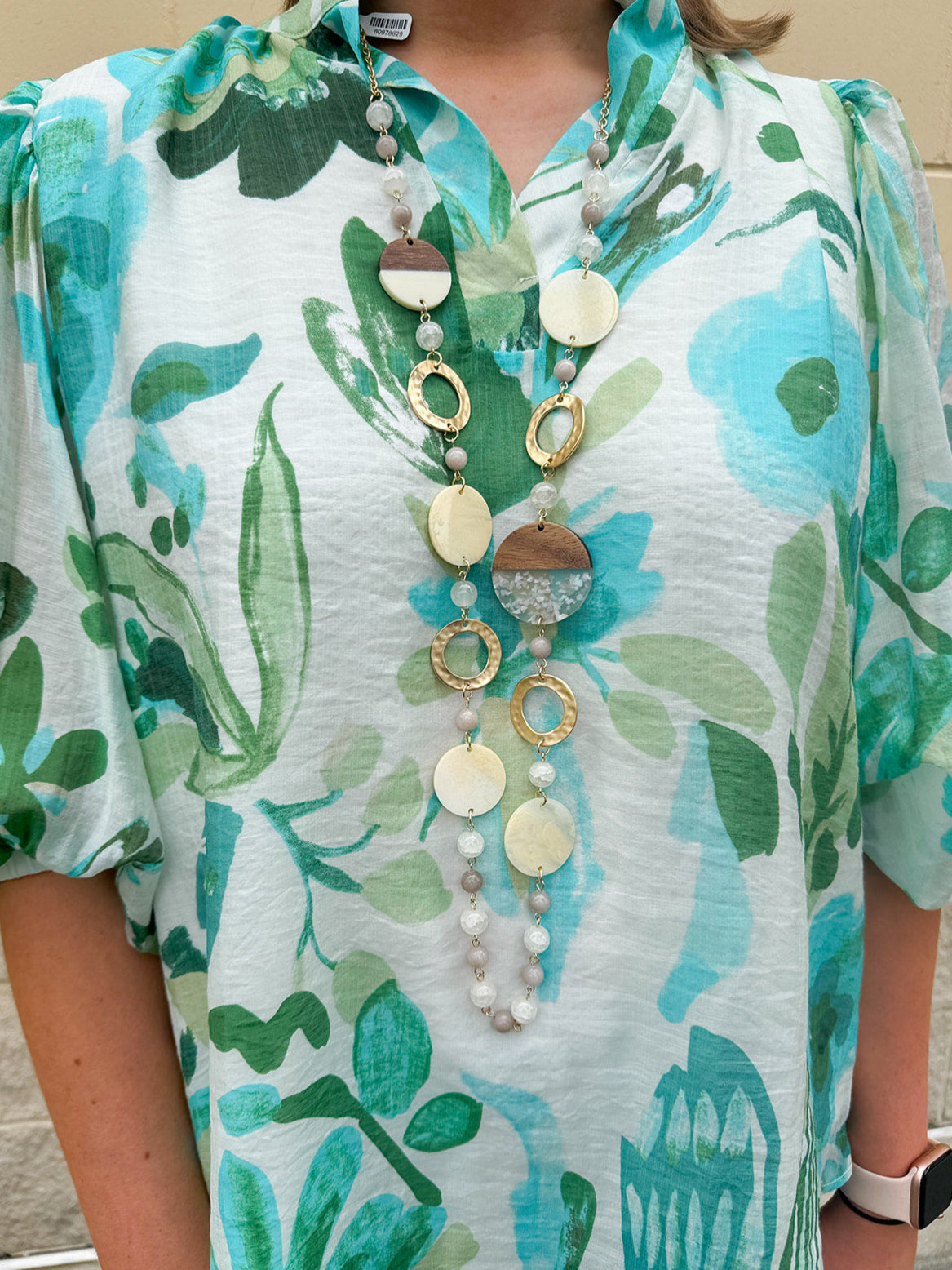 Long oatmeal-colored necklace with mixed circle and bead design, featuring neutral stones and delicate chain