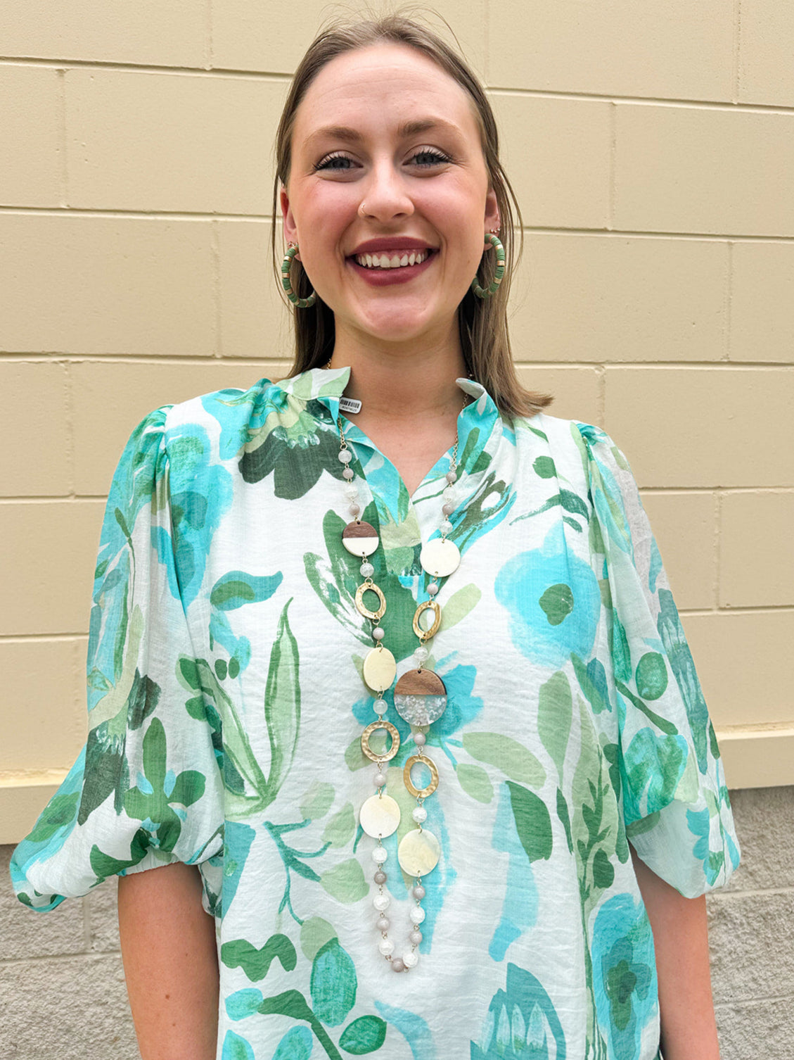Long oatmeal-colored necklace with mixed circle and bead design, featuring neutral stones and delicate chain