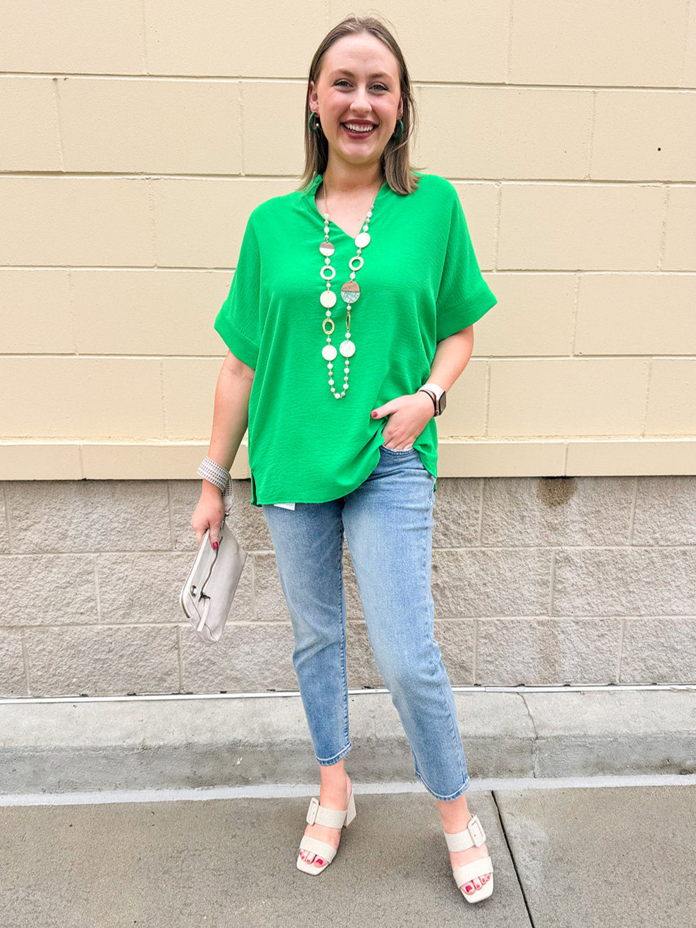 Kelly green blouse with frilled V-neckline, short dolman sleeves, and banded cuffs—bright, stylish, and feminine.
