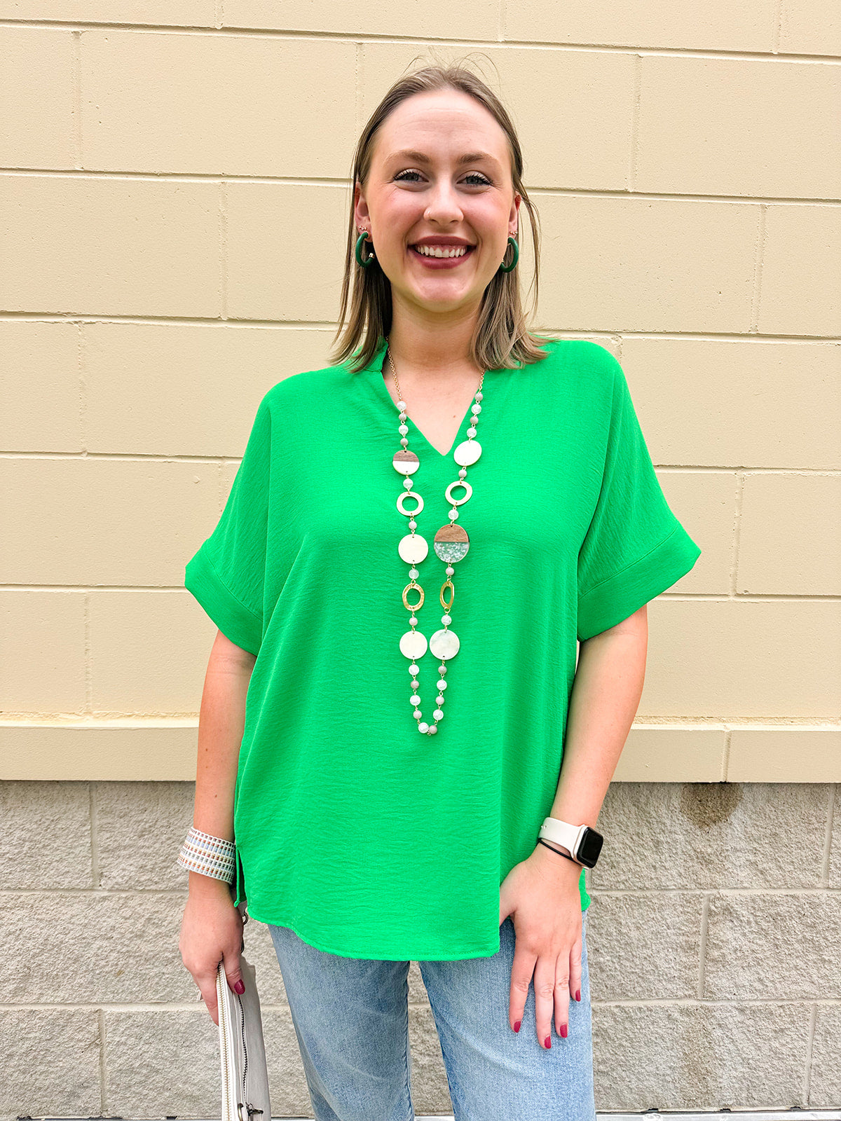 Kelly green blouse with frilled V-neckline, short dolman sleeves, and banded cuffs—bright, stylish, and feminine.
