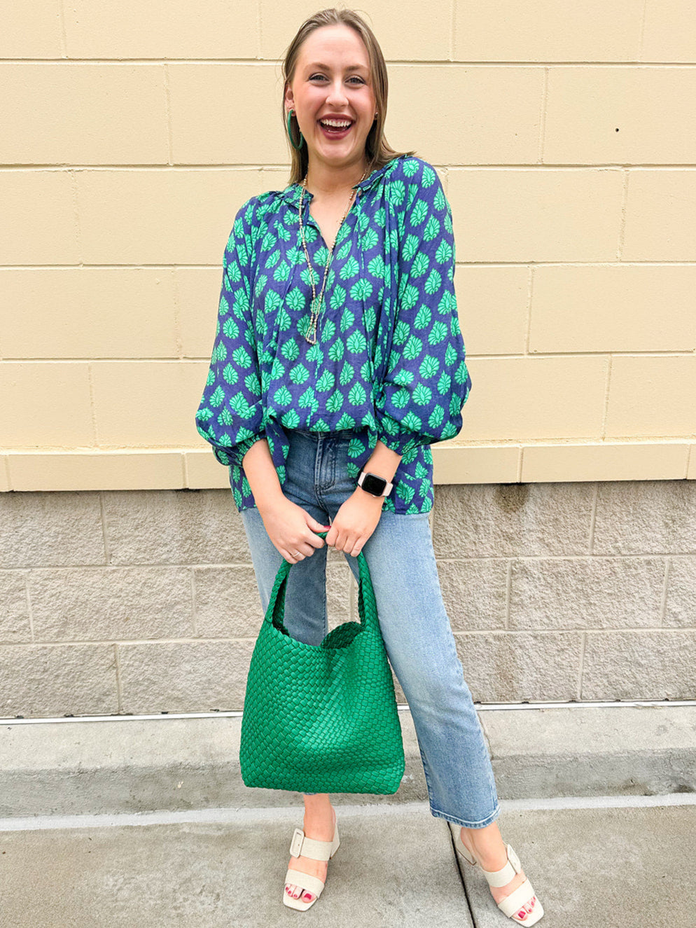 Flowy navy and green patterned blouse with tie-neck, ruffle collar, dolman sleeves, and elastic cuffs—lightweight and oversized