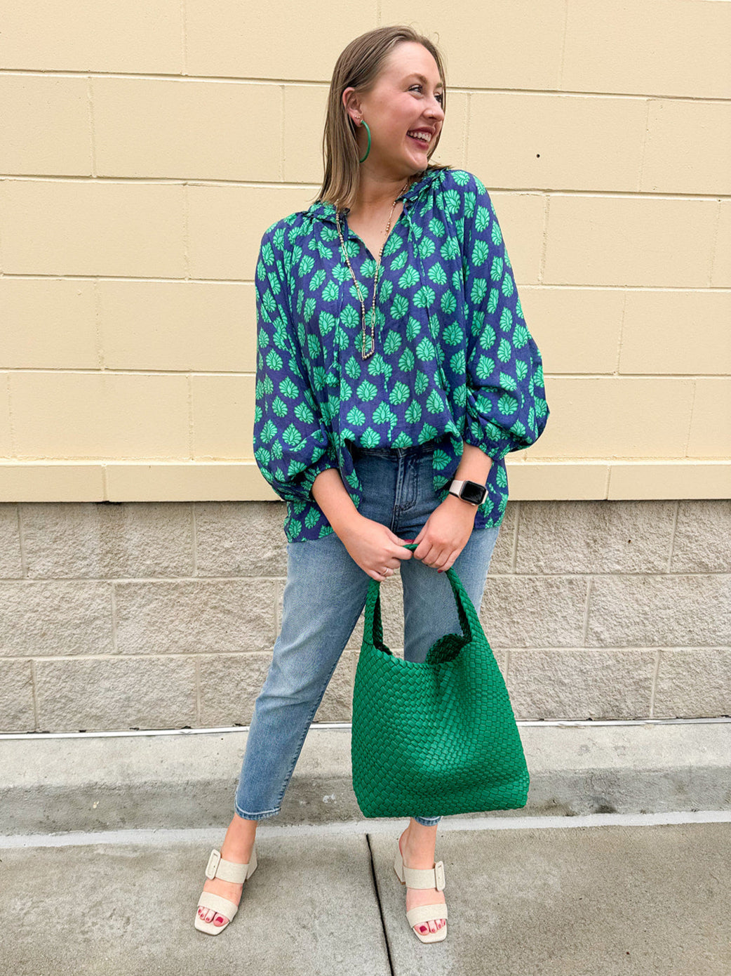 Flowy navy and green patterned blouse with tie-neck, ruffle collar, dolman sleeves, and elastic cuffs—lightweight and oversized