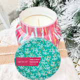 Capri Blue Holiday Pattern Play Tinsel & Spice 19oz candle in red jar with green lid and green, gold, and cream leaf design.