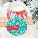 Capri Blue Holiday Pattern Play Tinsel & Spice 8oz candle in red jar with green lid and green, gold, and cream leaf design.