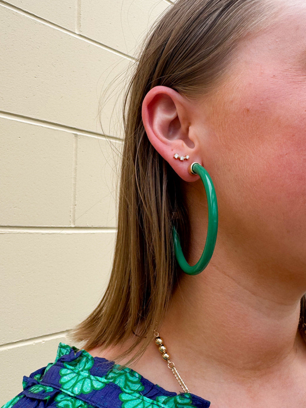 Kelly green acrylic hoop earrings with 2-inch diameter—lightweight and bold statement accessory