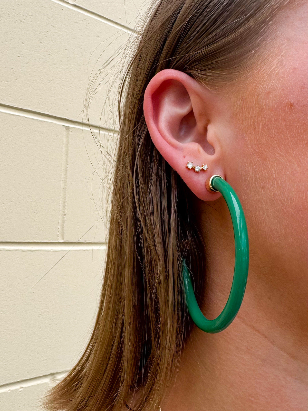 Kelly green acrylic hoop earrings with 2-inch diameter—lightweight and bold statement accessory