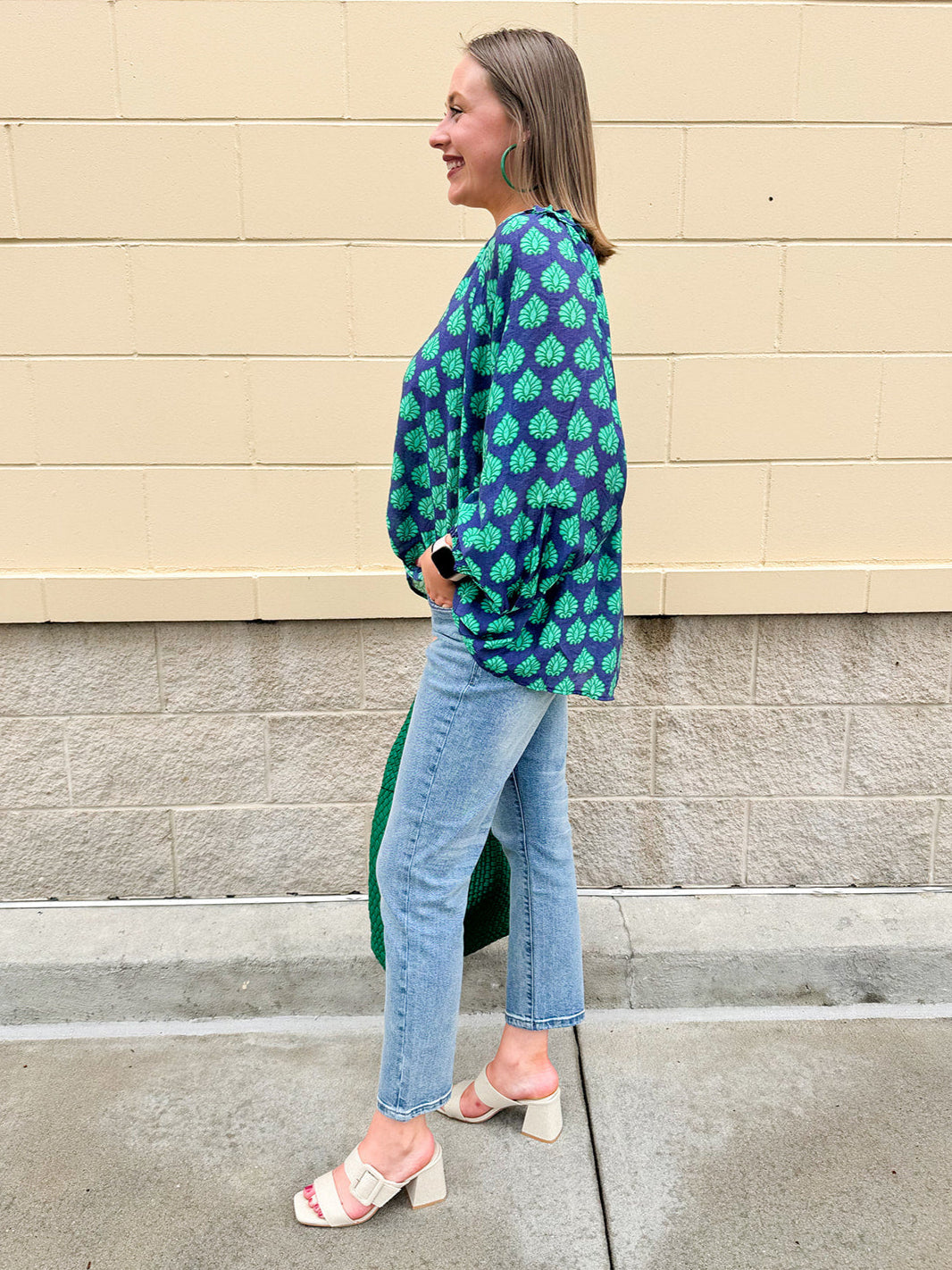 Flowy navy and green patterned blouse with tie-neck, ruffle collar, dolman sleeves, and elastic cuffs—lightweight and oversized