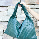 Green woven shoulder bag with soft structure and magnetic closure, designed for stylish and functional everyday use