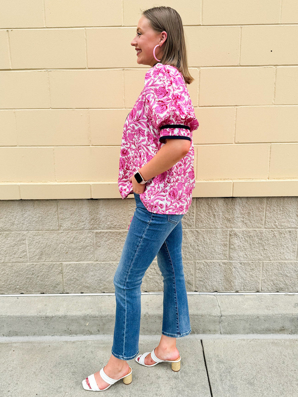 Pink caftan-style top with split neckline and botanical floral print, lightweight and relaxed fit