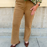 Deep camel acid-washed high-waisted bootcut pants with frayed hem.