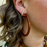Café brown 2” acrylic hoop earrings with lightweight, hypoallergenic design.