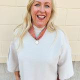 Sand beige viscose sweater with bell sleeves, high-low hem, and side slits.