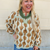 Printed V-neck long sleeve blouse with brown, cream, and olive tones, contrasting stripe accents, and decorative trim.