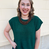 Ash jade short-sleeve lightweight sweater with center seam, rolled cuffs, and side slits.