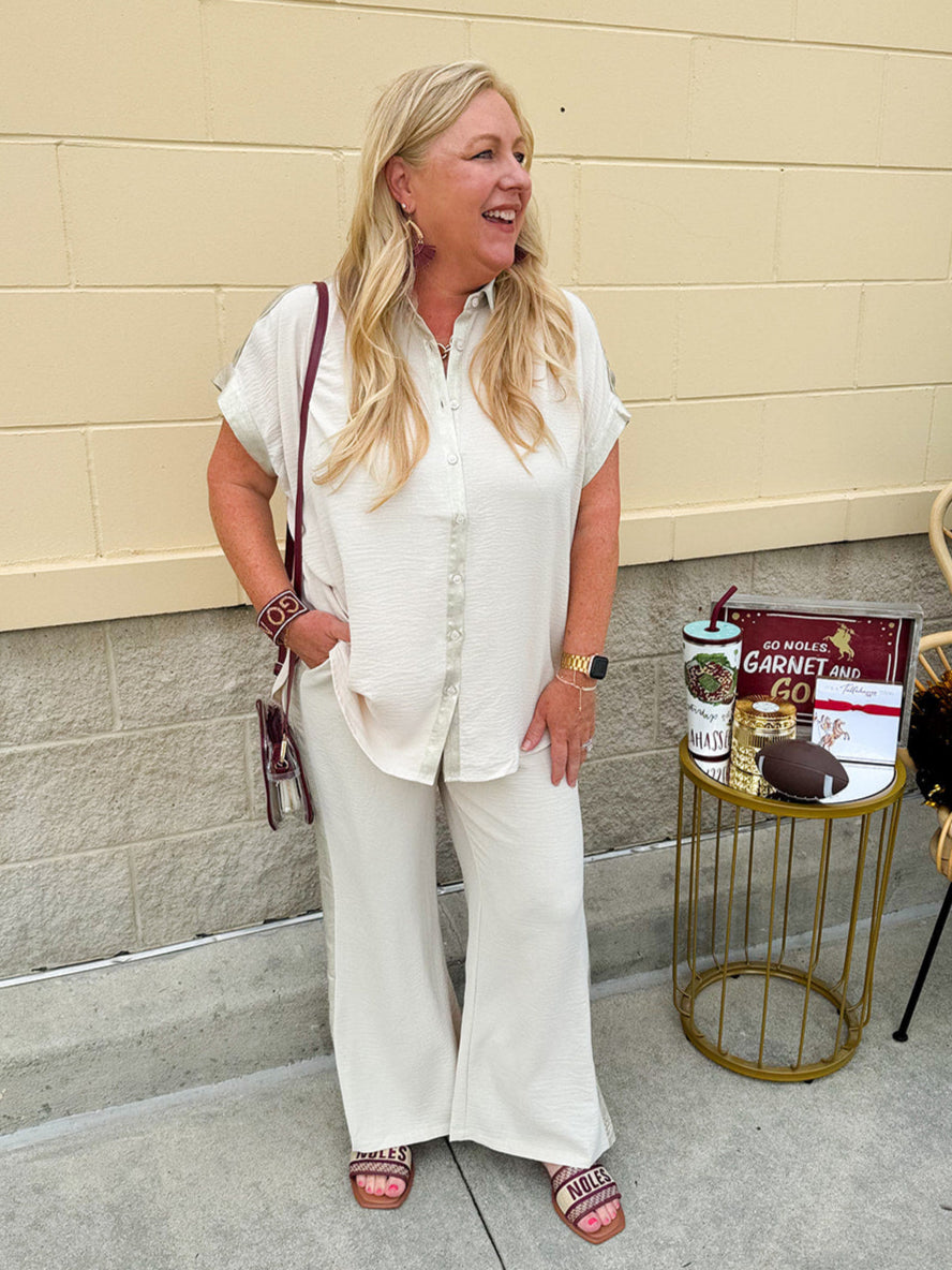 Oatmeal wide leg pants with gold side piping and drawstring waist