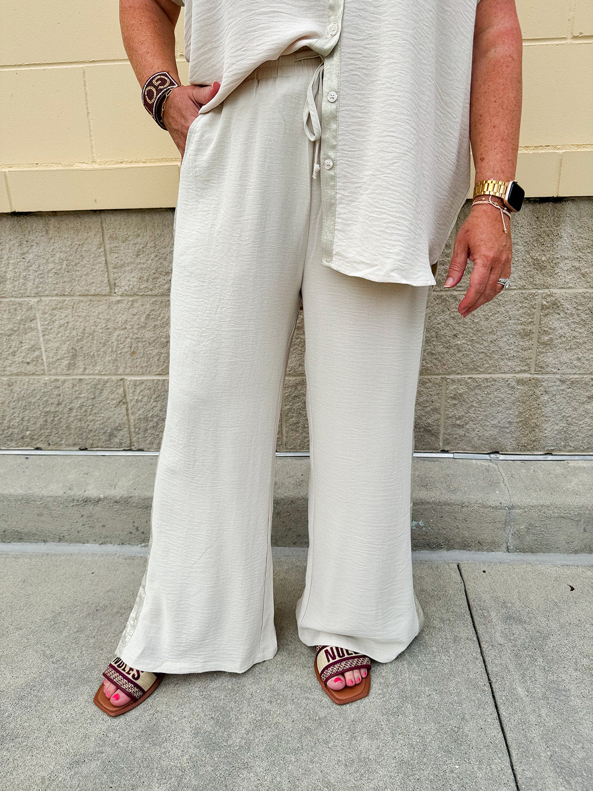 Oatmeal wide leg pants with gold side piping and drawstring waist