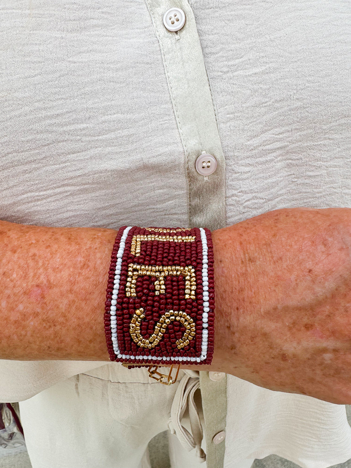 Garnet and gold beaded cuff bracelet featuring the FSU logo, perfect for showing team spirit.