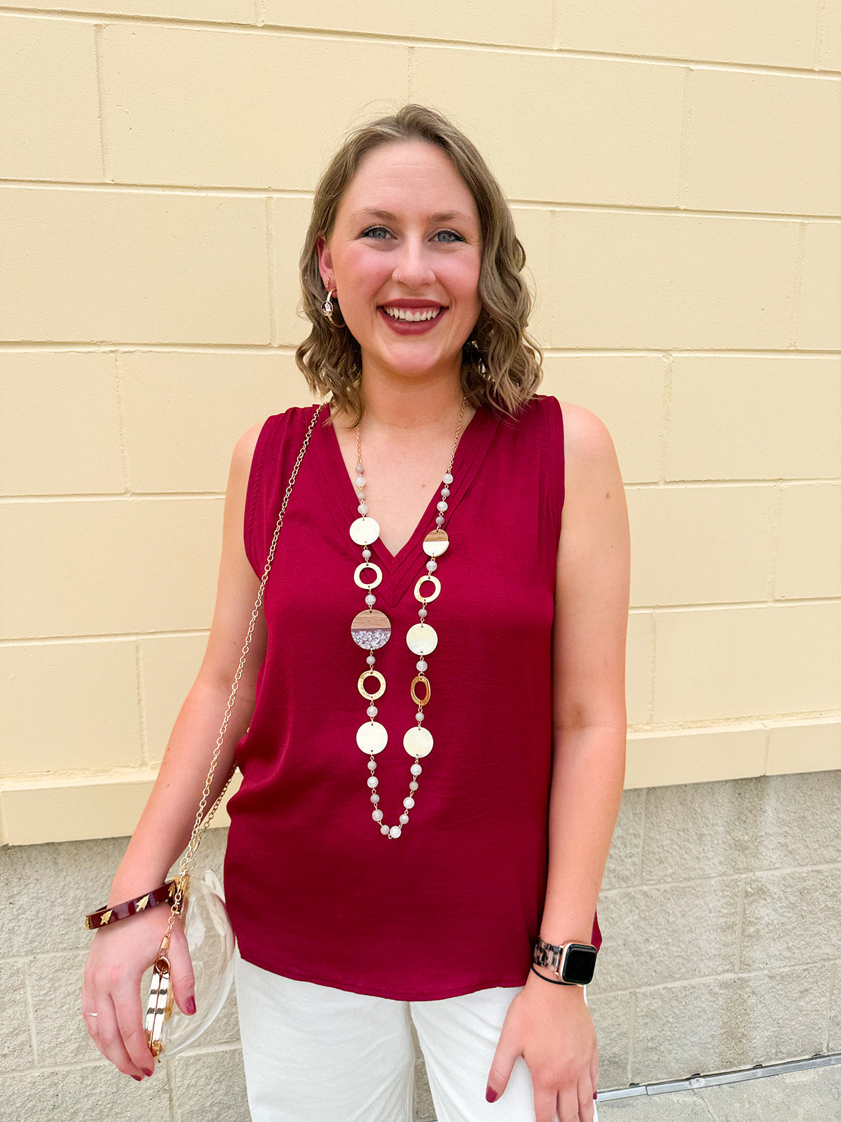 Garnet sleeveless V-neck tank top with pleated neckline detail and a relaxed, lightweight fit—perfect for warm-weather gamedays.