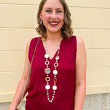 Long oatmeal-colored necklace with mixed circle and bead design, featuring neutral stones and delicate chain