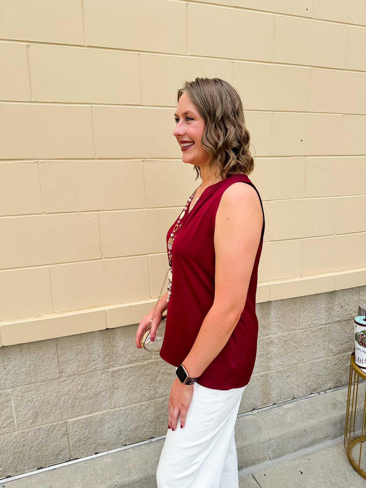 Garnet sleeveless V-neck tank top with pleated neckline detail and a relaxed, lightweight fit—perfect for warm-weather gamedays.