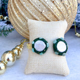 Gold cuff bracelet with freshwater pearls on each end surrounded by green gemstones, handmade by Easton Elle.