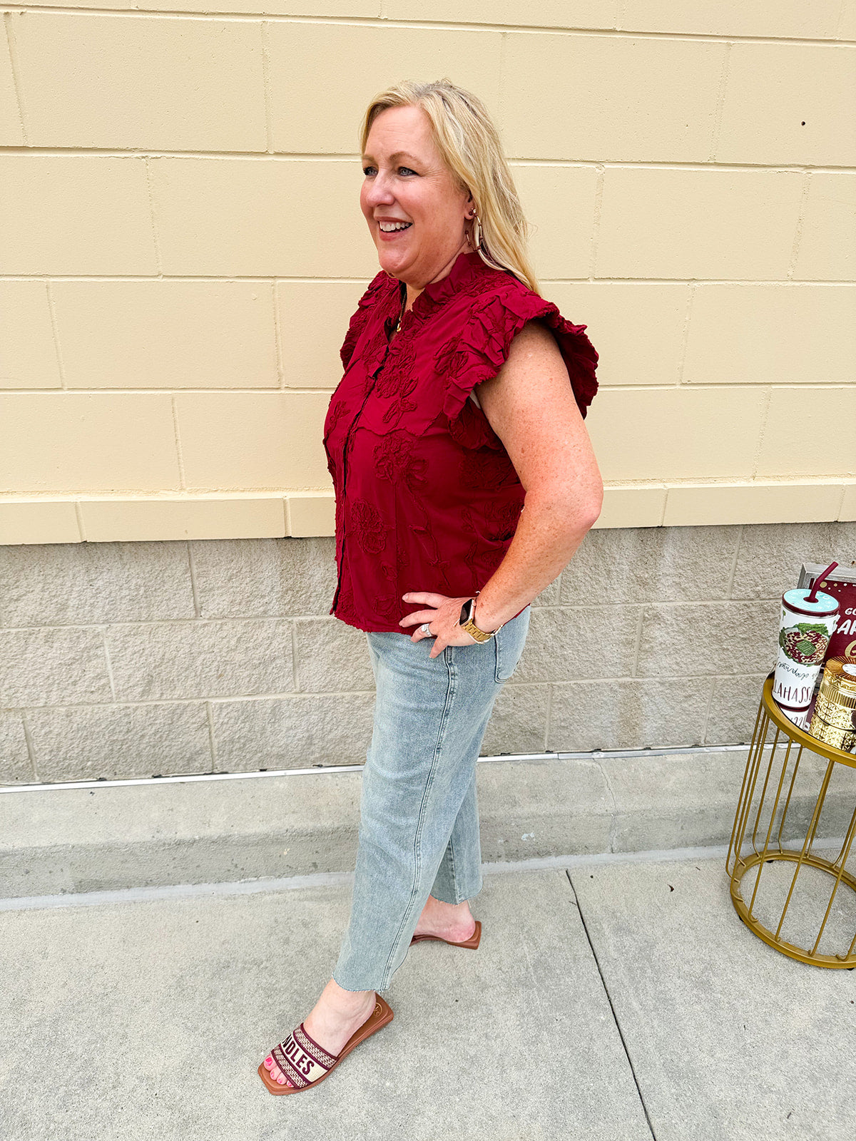 Model wearing light wash, cropped wide leg jeans with raw hem and light distressing. Jeans feature a mid-rise waist and tummy control panel.