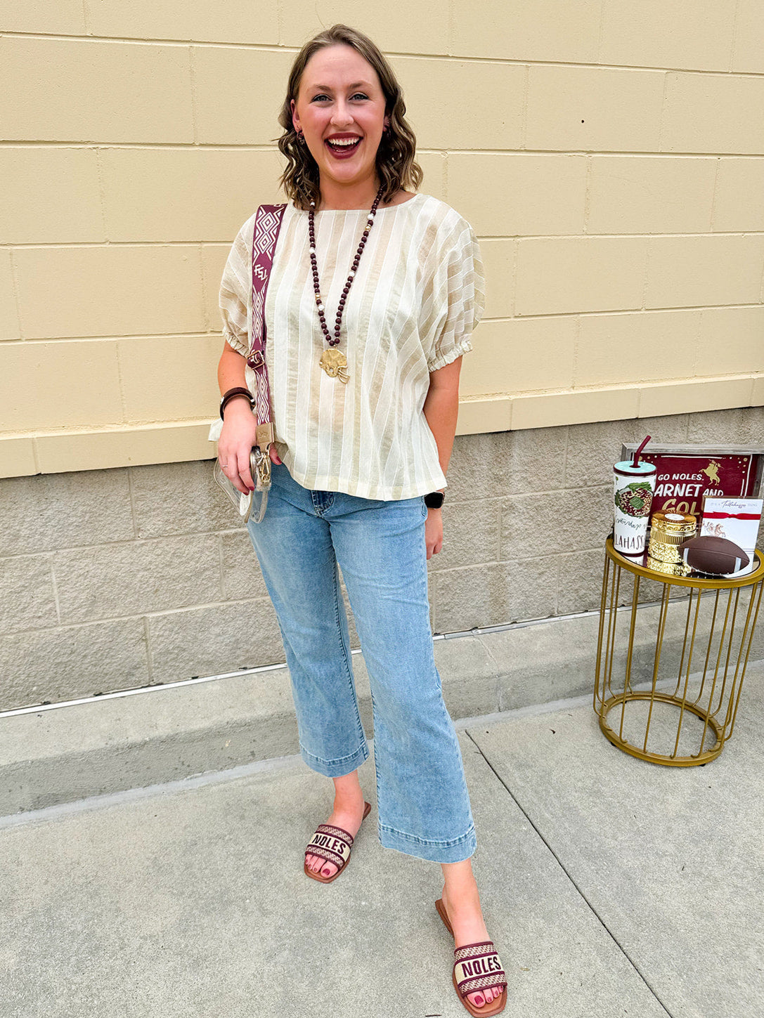 Cream and gold striped round-neck top with dolman sleeves and elastic cuffs, styled for summer.