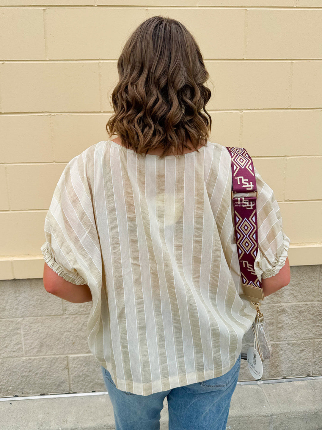 Cream and gold striped round-neck top with dolman sleeves and elastic cuffs, styled for summer.