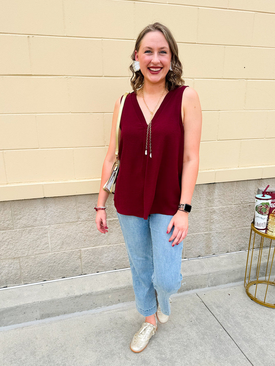 Garnet sleeveless V-neck tank with pleated detail at neckline, made in USA fabric.