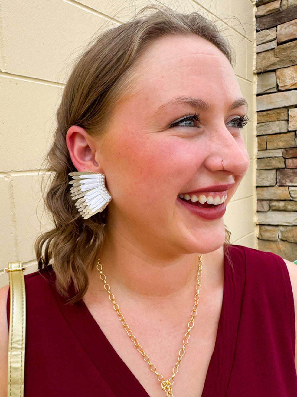Layered feather-style earrings with white and gold sculpted plastic pieces. Bold, lightweight, and perfect for standout Gameday style.