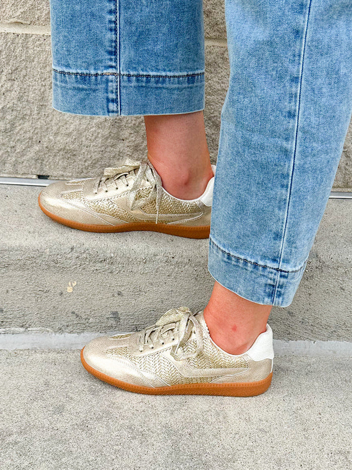 Gold and cream low-top sneaker with subtle metallic sheen, tan sole, and lace-up front—perfect for FSU gameday
