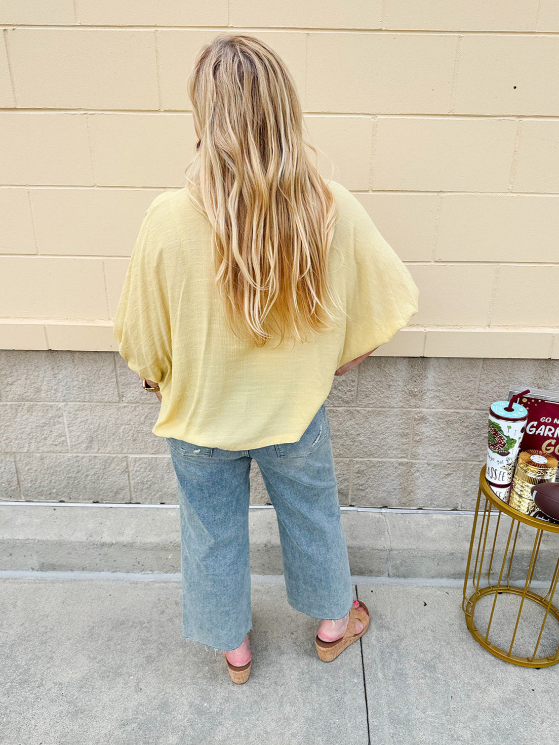 Golden yellow short sleeve blouse with a relaxed fit and dolman sleeves, styled for casual or dressy occasions.