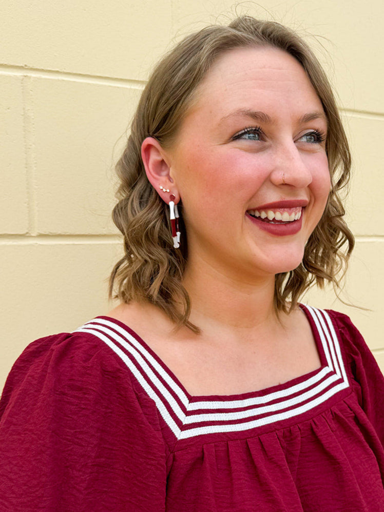 Garnet and white striped enamel hoop earrings with gold trim