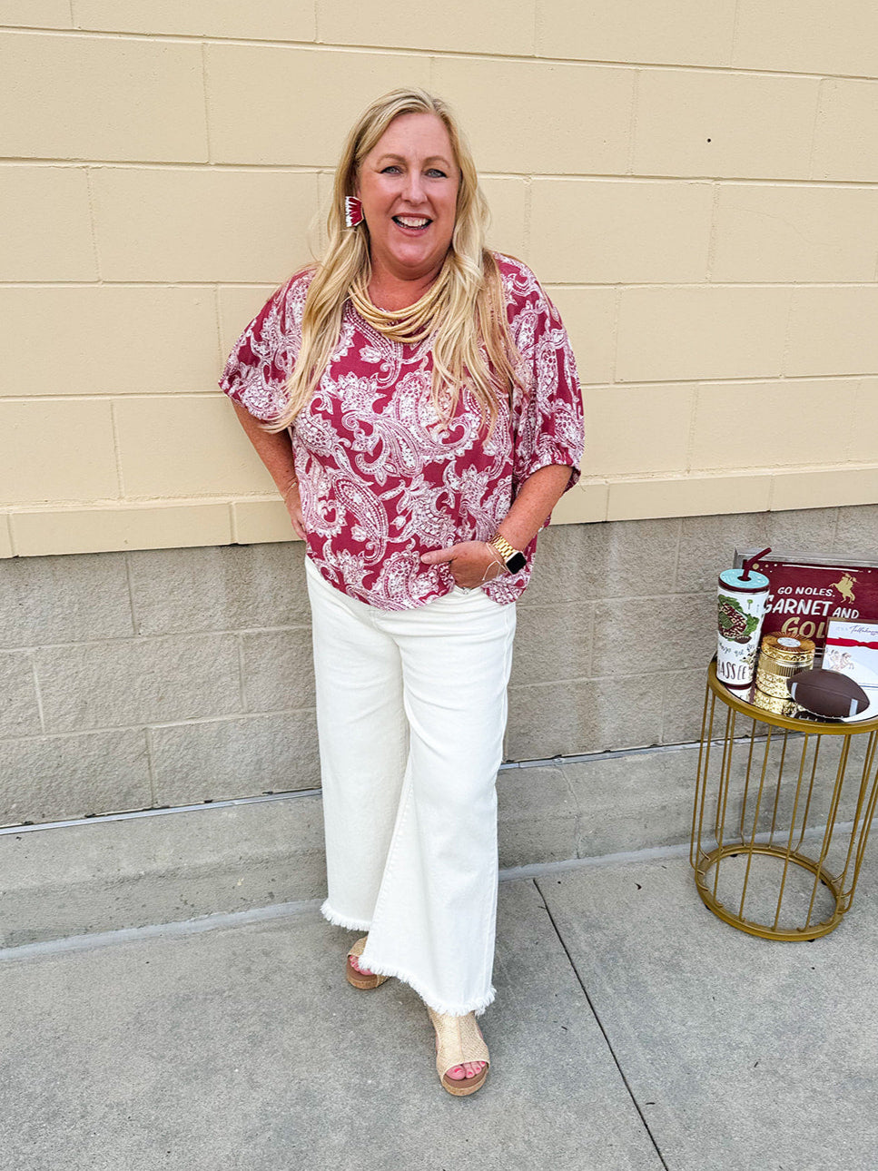 Lightweight garnet top with white paisley print, boat neckline, and loose dolman sleeves.