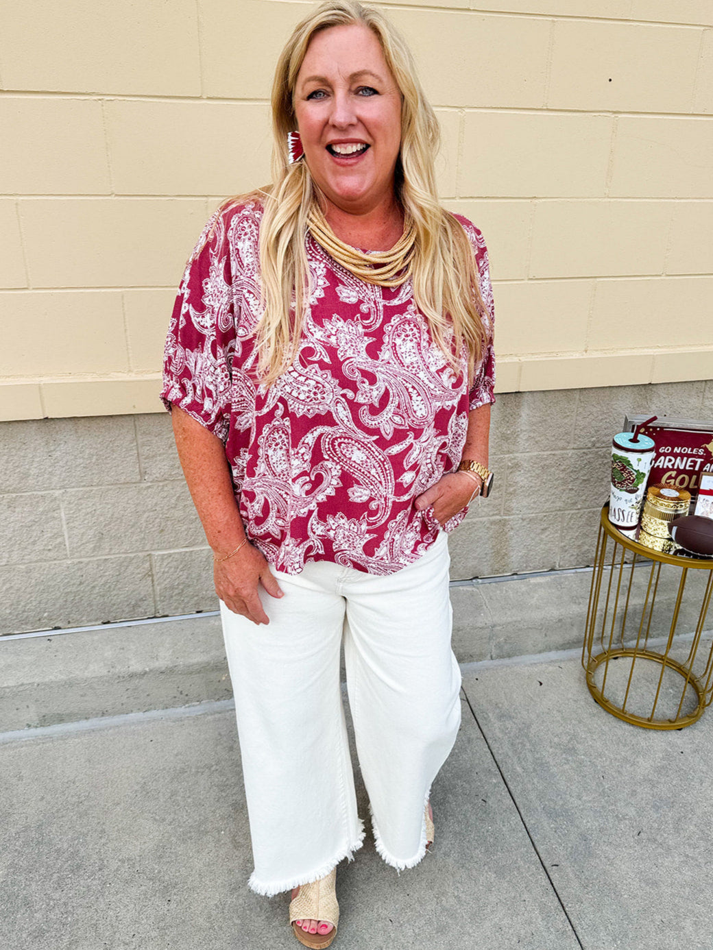 Lightweight garnet top with white paisley print, boat neckline, and loose dolman sleeves.