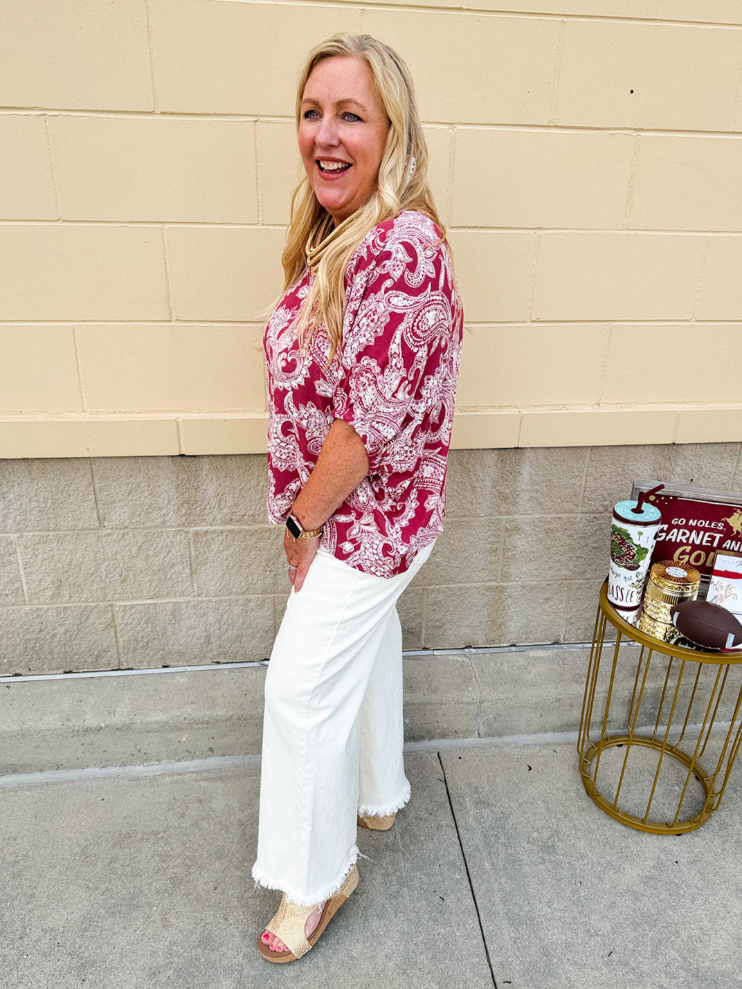 Lightweight garnet top with white paisley print, boat neckline, and loose dolman sleeves.