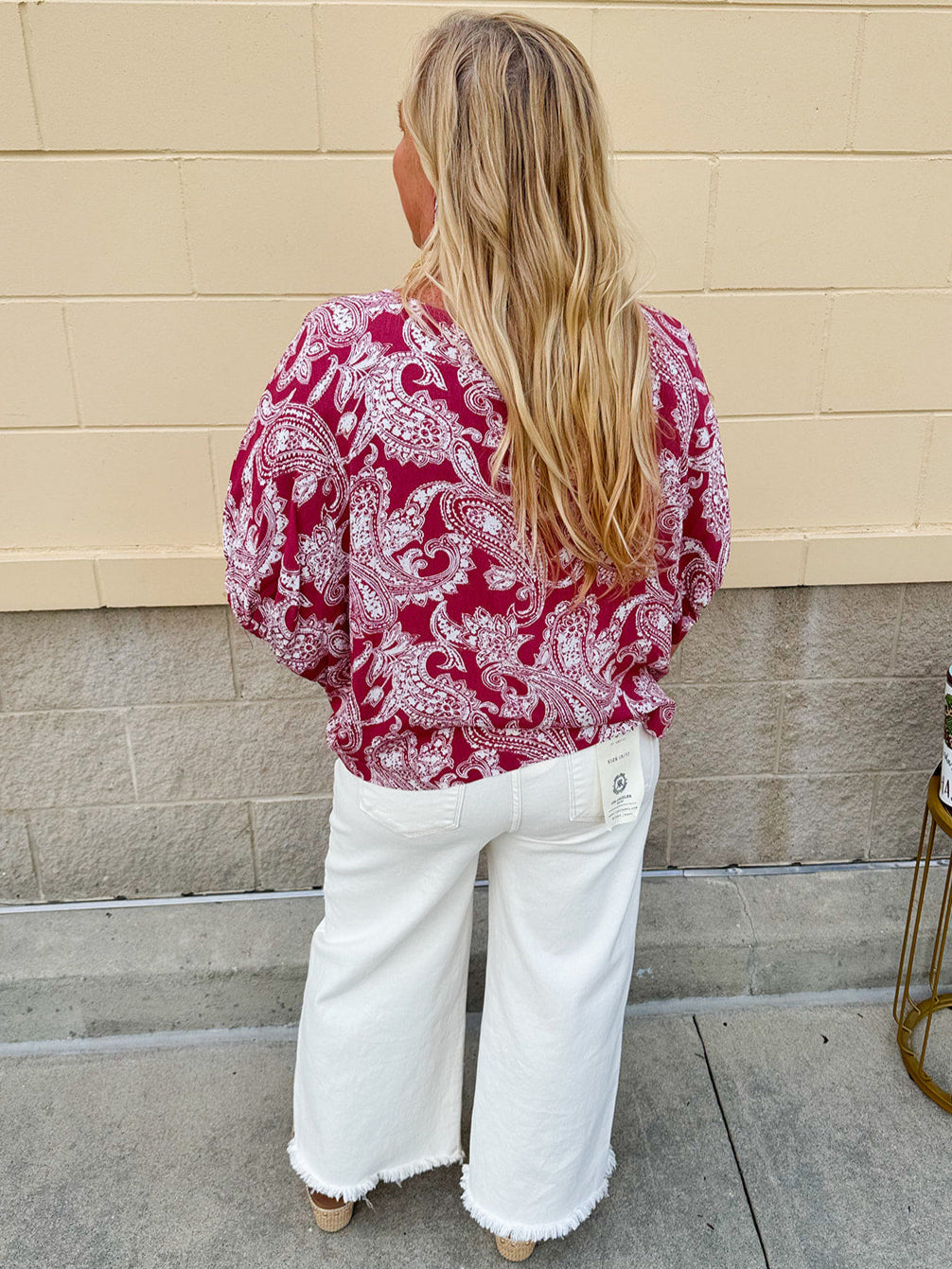 Lightweight garnet top with white paisley print, boat neckline, and loose dolman sleeves.