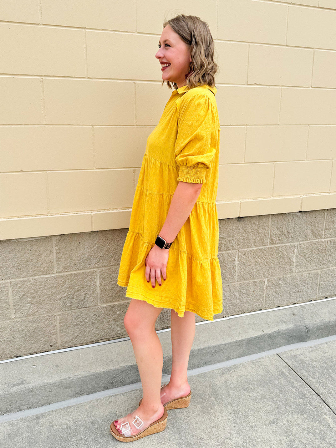 Mustard cotton mini dress with a collar, tiered A-line shape, and smocked cuff balloon sleeves—perfect for gameday style.