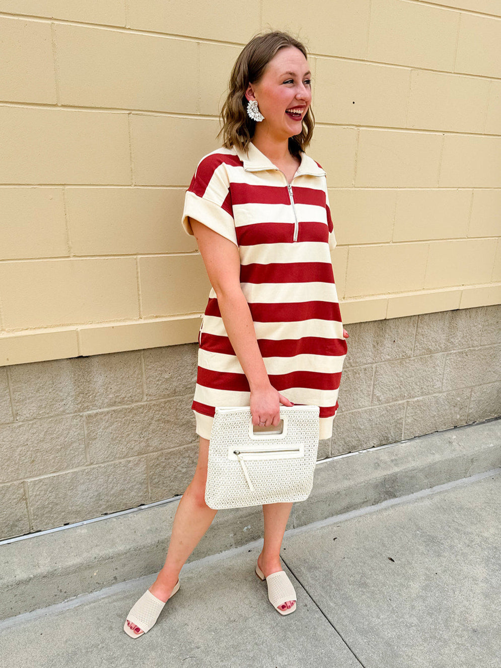 Mini dress with a zippered split-neck collar, cuffed sleeves, and colorblock-style stripes—sporty, stylish, and perfect for Gameday wear.