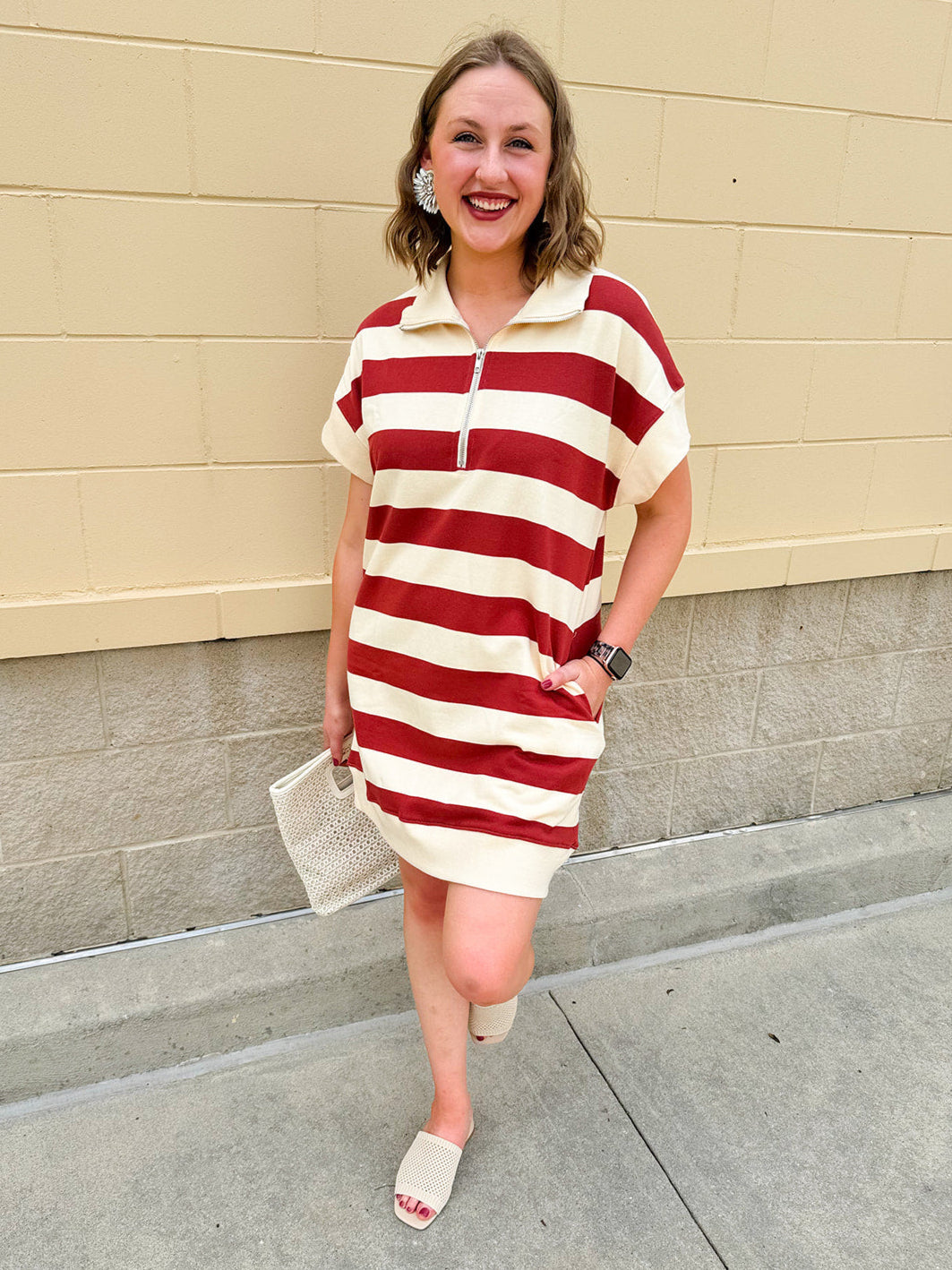 Mini dress with a zippered split-neck collar, cuffed sleeves, and colorblock-style stripes—sporty, stylish, and perfect for Gameday wear.