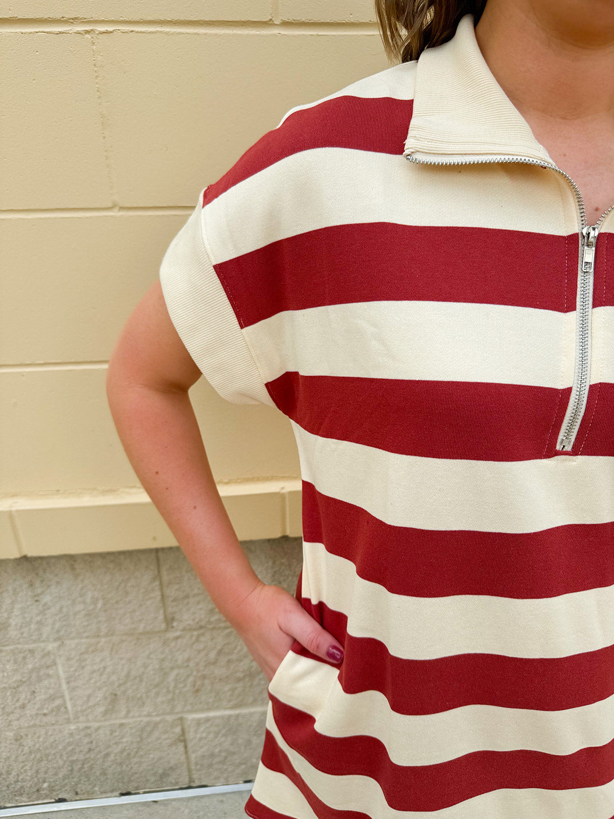 Mini dress with a zippered split-neck collar, cuffed sleeves, and colorblock-style stripes—sporty, stylish, and perfect for Gameday wear.